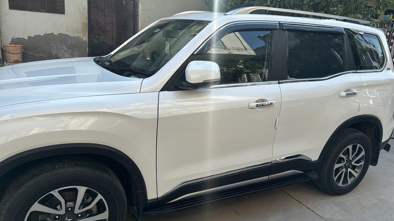 A white Mahindra SUV parked and ready for the group
