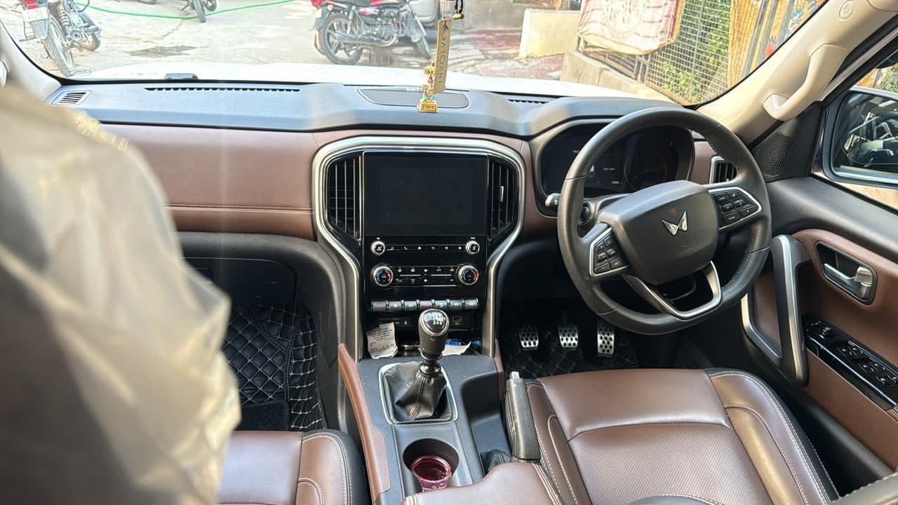 The leather interior of the touring SUV, the gear console in the foreground