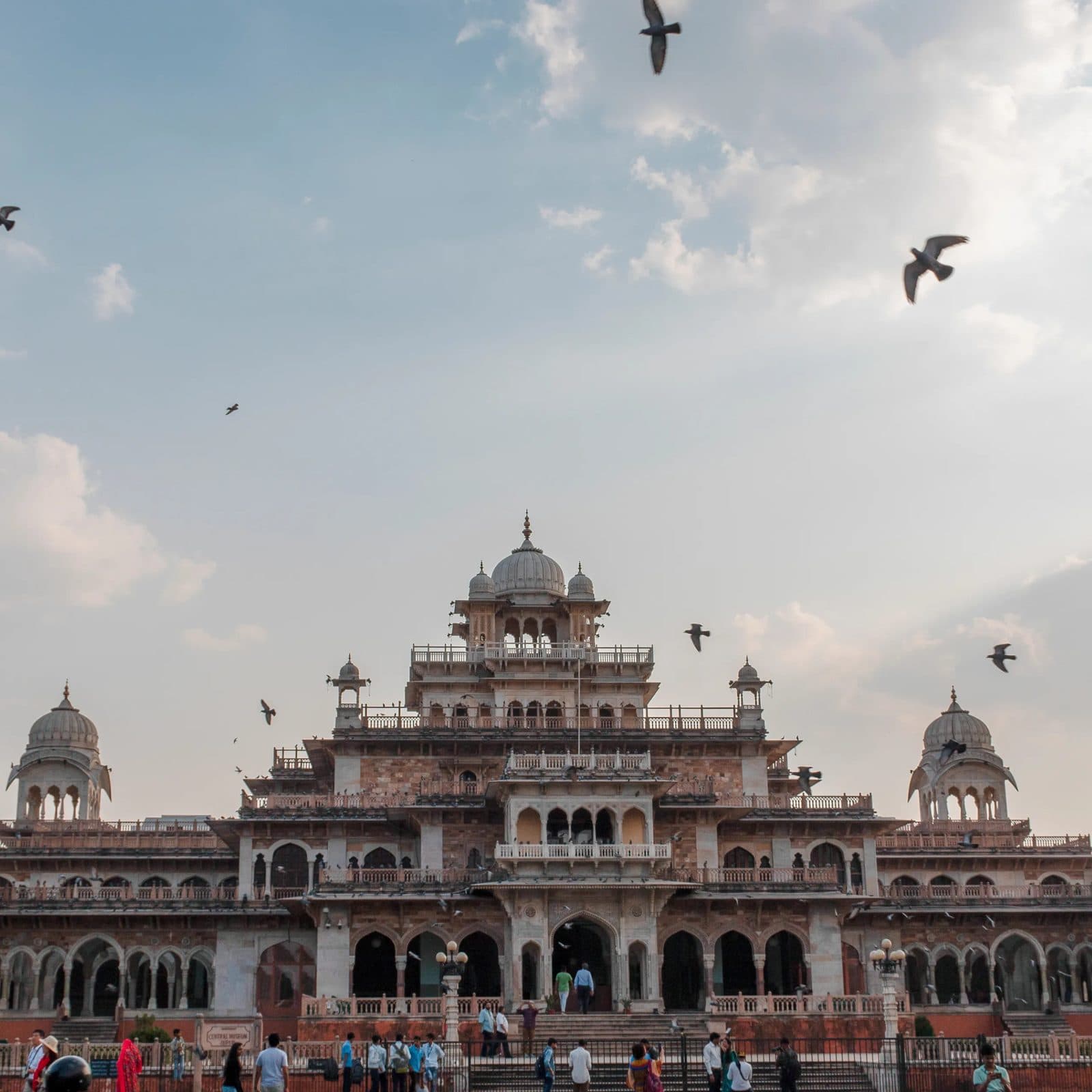 The Indo-Saracenic Albert Hall Museum in Jaipur with pigeons wheeling overhead