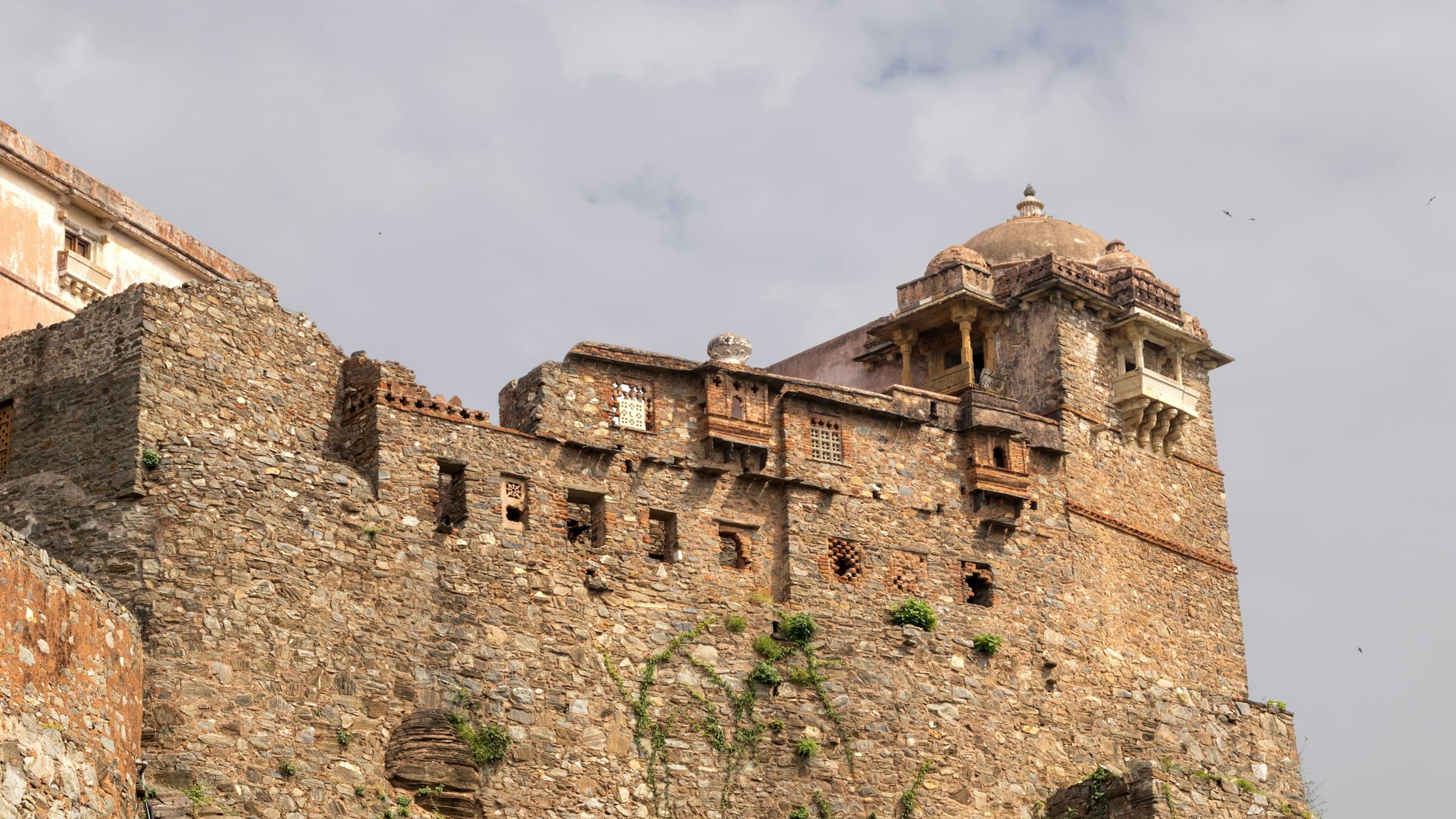 Weathered ramparts of Kumbhalgarh Fort in the Aravalli hills