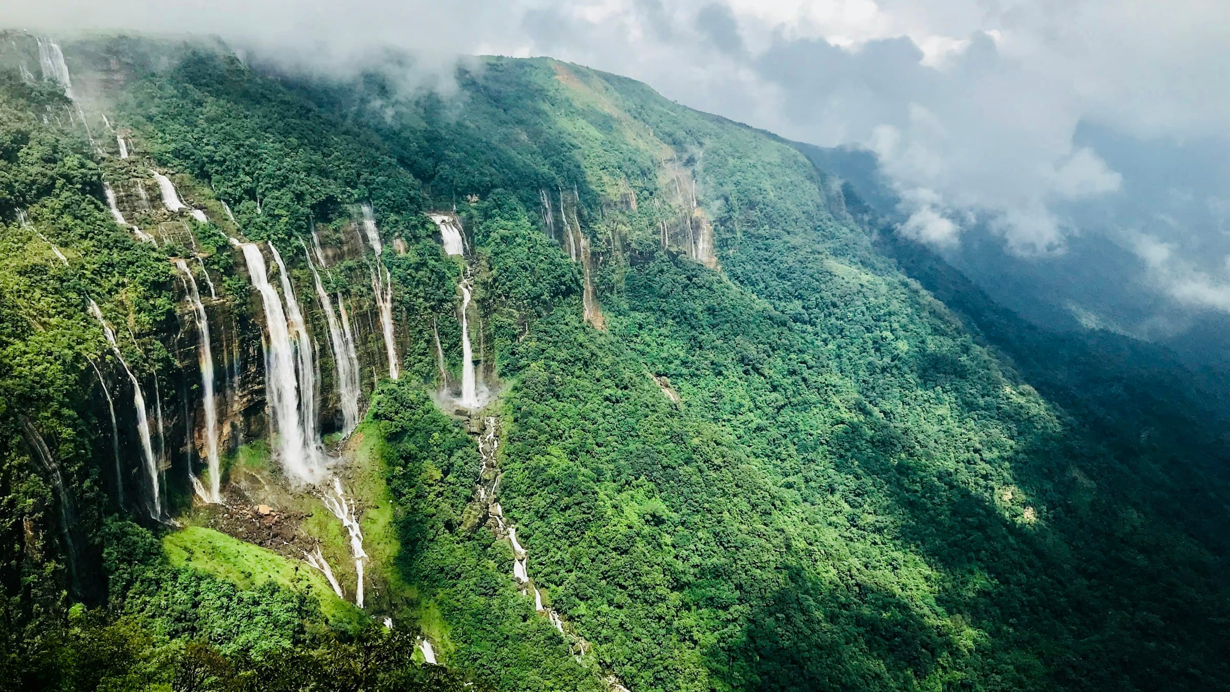 Seven Sister Falls tumbling down a green mountainside near Shillong, Meghalaya's hill capital.