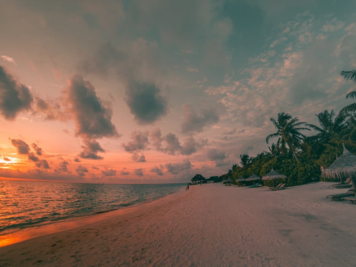 A figure on the shore at sunset near Port Blair