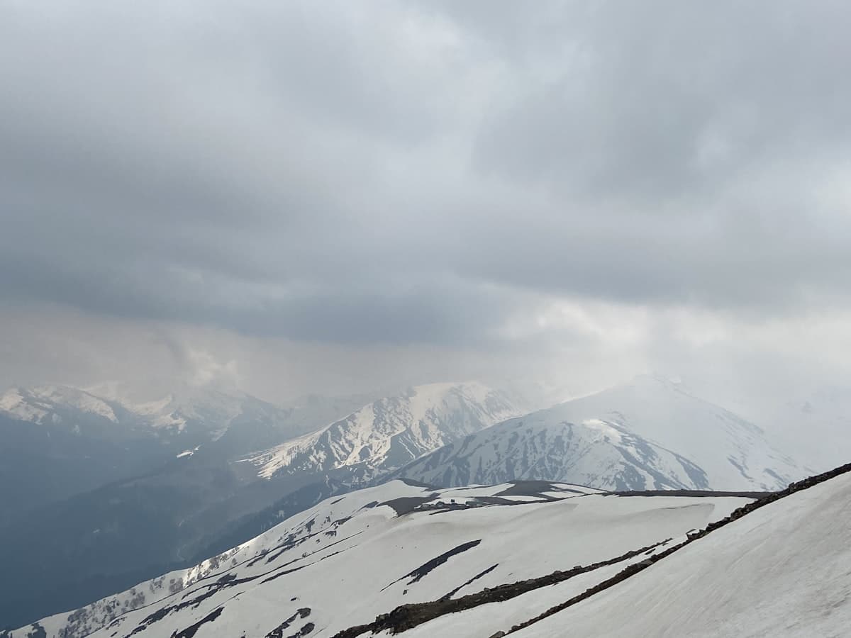 A skier descends an open snow slope at Gulmarg.