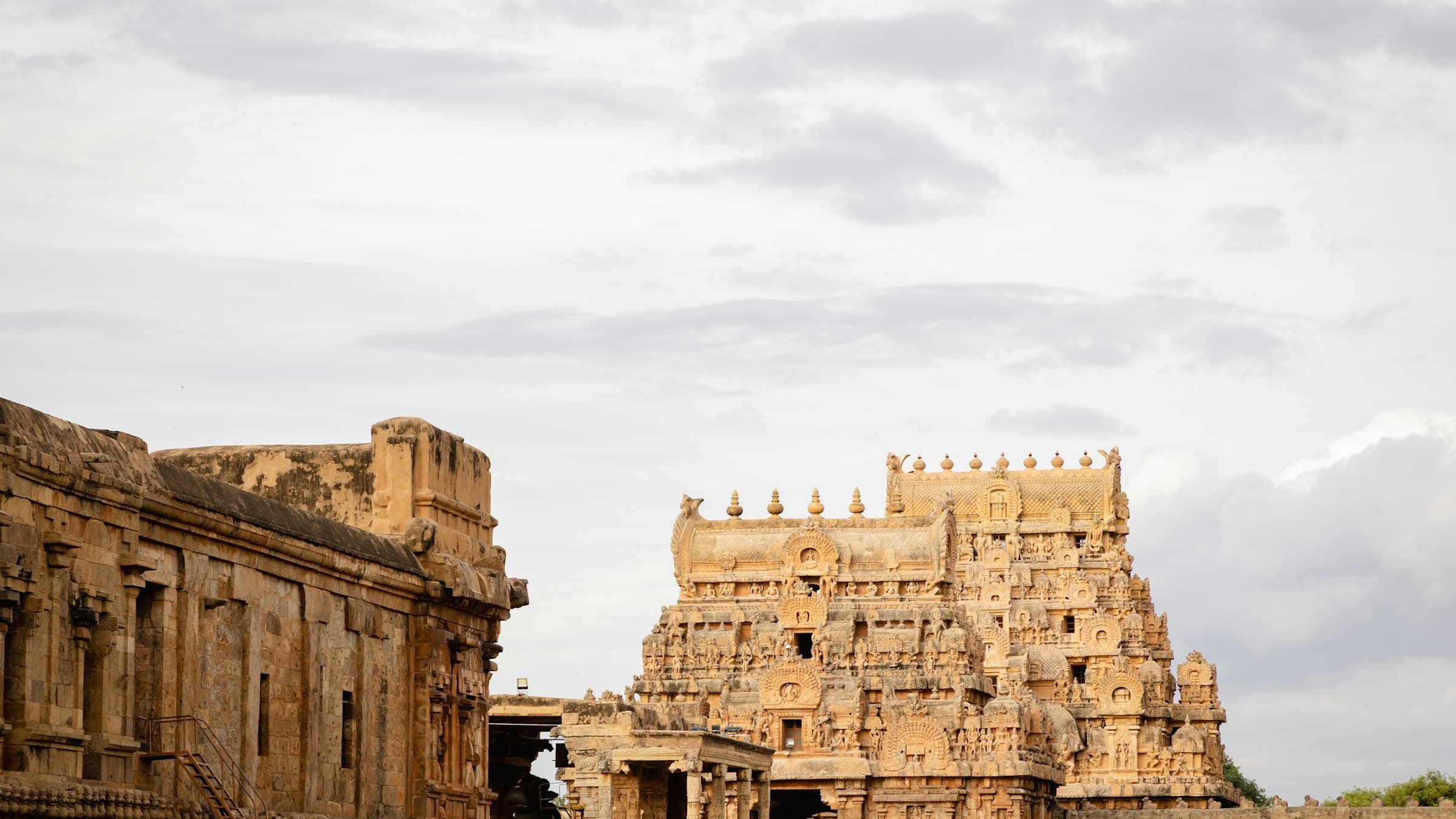 The Brihadeeswarar Temple complex under a cloudy sky at Thanjavur (Tanjore), Tamil Nadu.