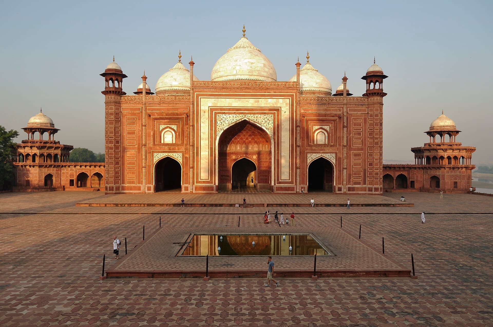 The red sandstone mosque beside the Taj Mahal with its white domes