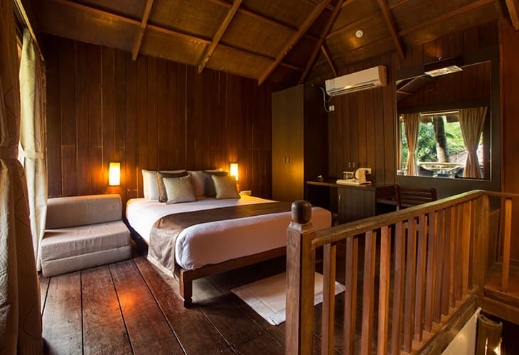 Exterior of a Nicobari Cottage at SeaShell Havelock, a wooden duplex among the trees