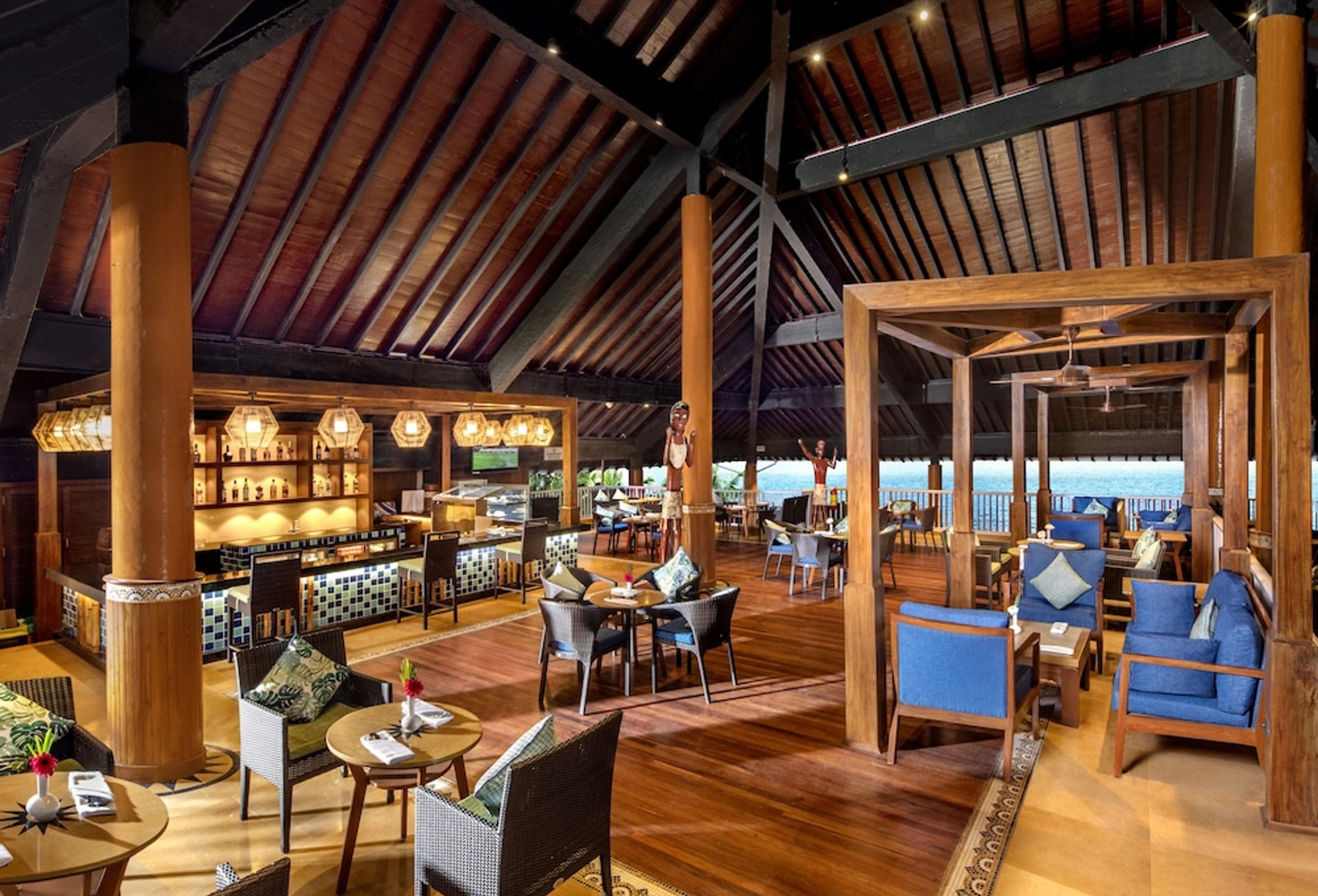 Swizzle Bar at Welcomhotel Bay Island, an open-air lounge with sea views past timber columns