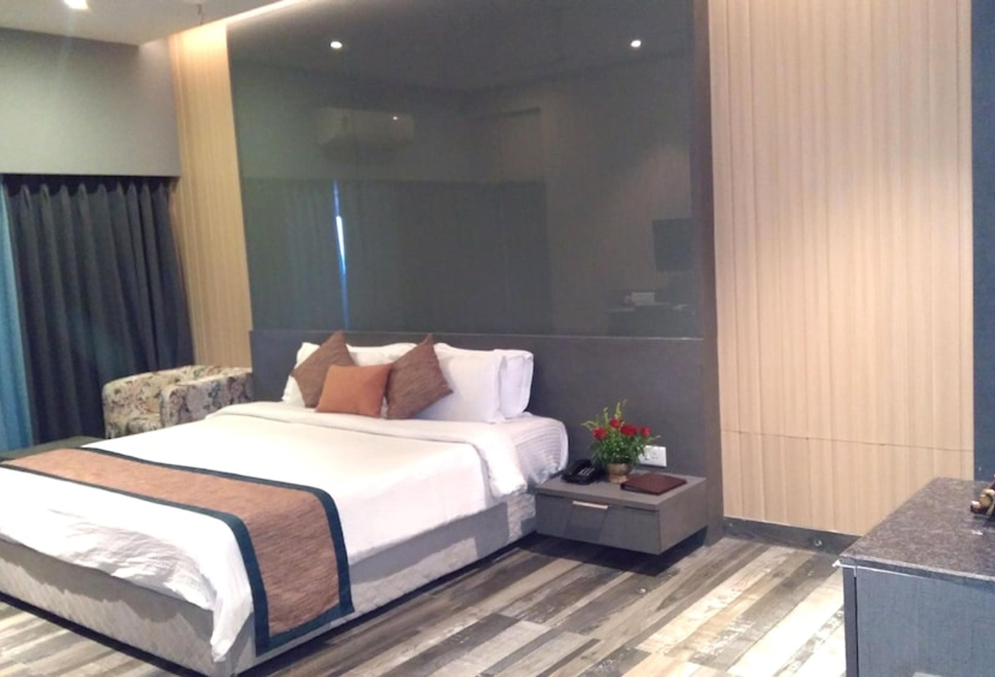 Premier Room at Sinclairs Bayview Port Blair with queen bed and dark wood accent wall