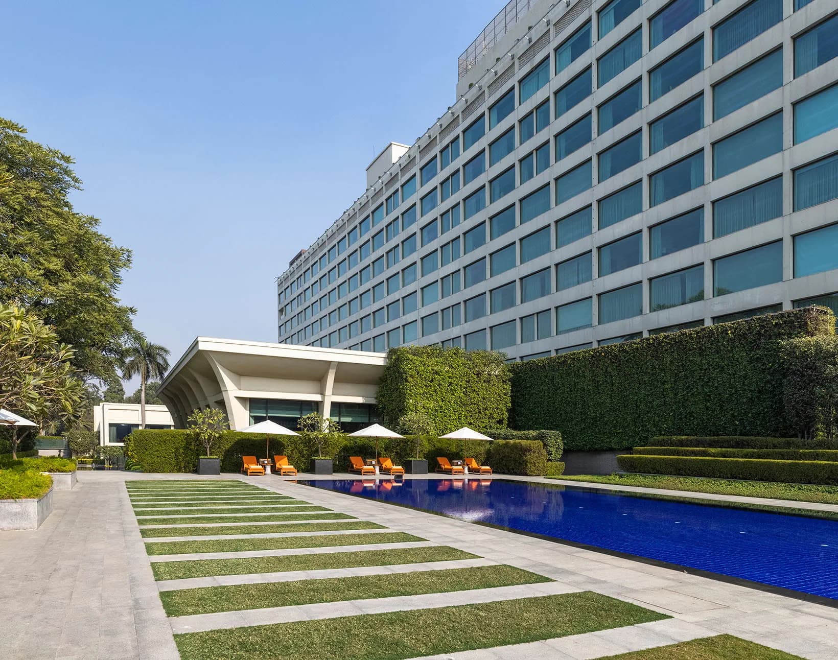 Poolside loungers and greenery at The Oberoi, New Delhi