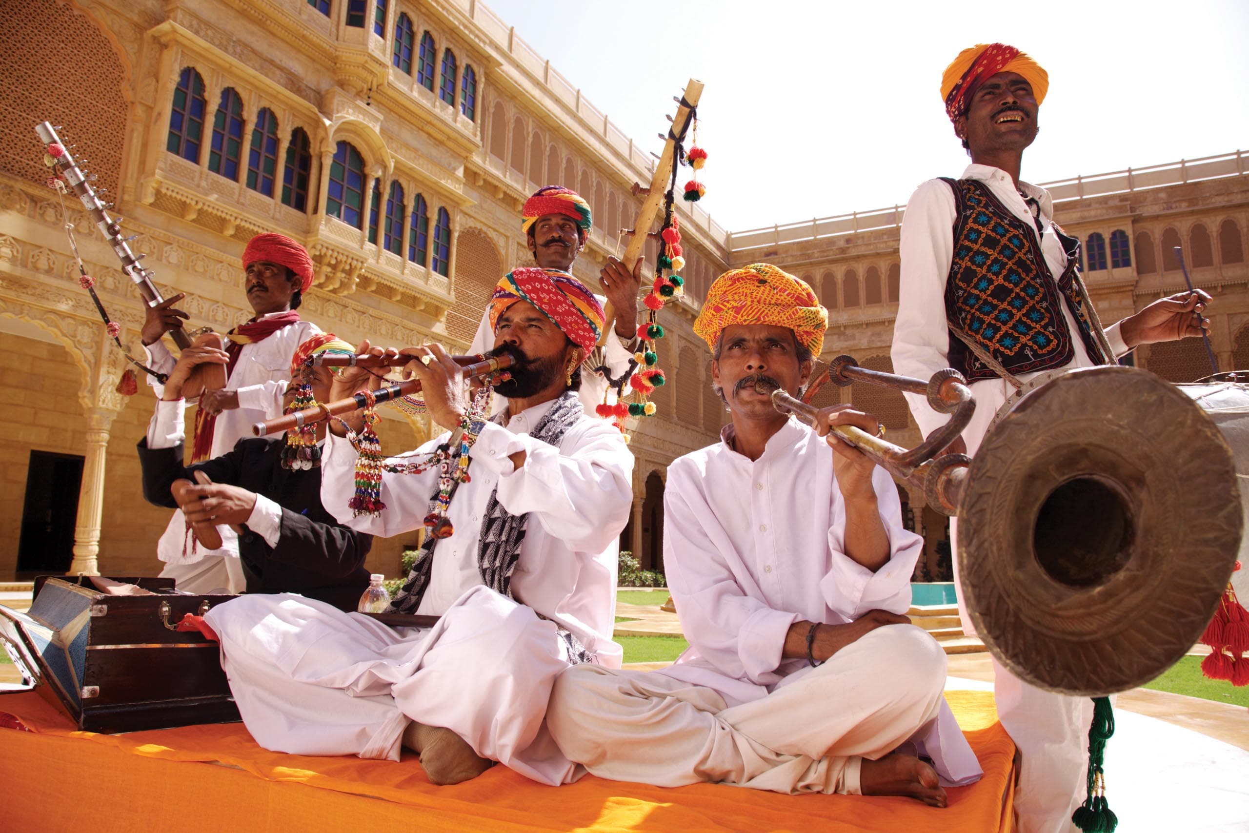 Traditional Rajasthani folk musicians performing in Suryagarh's courtyard for guests