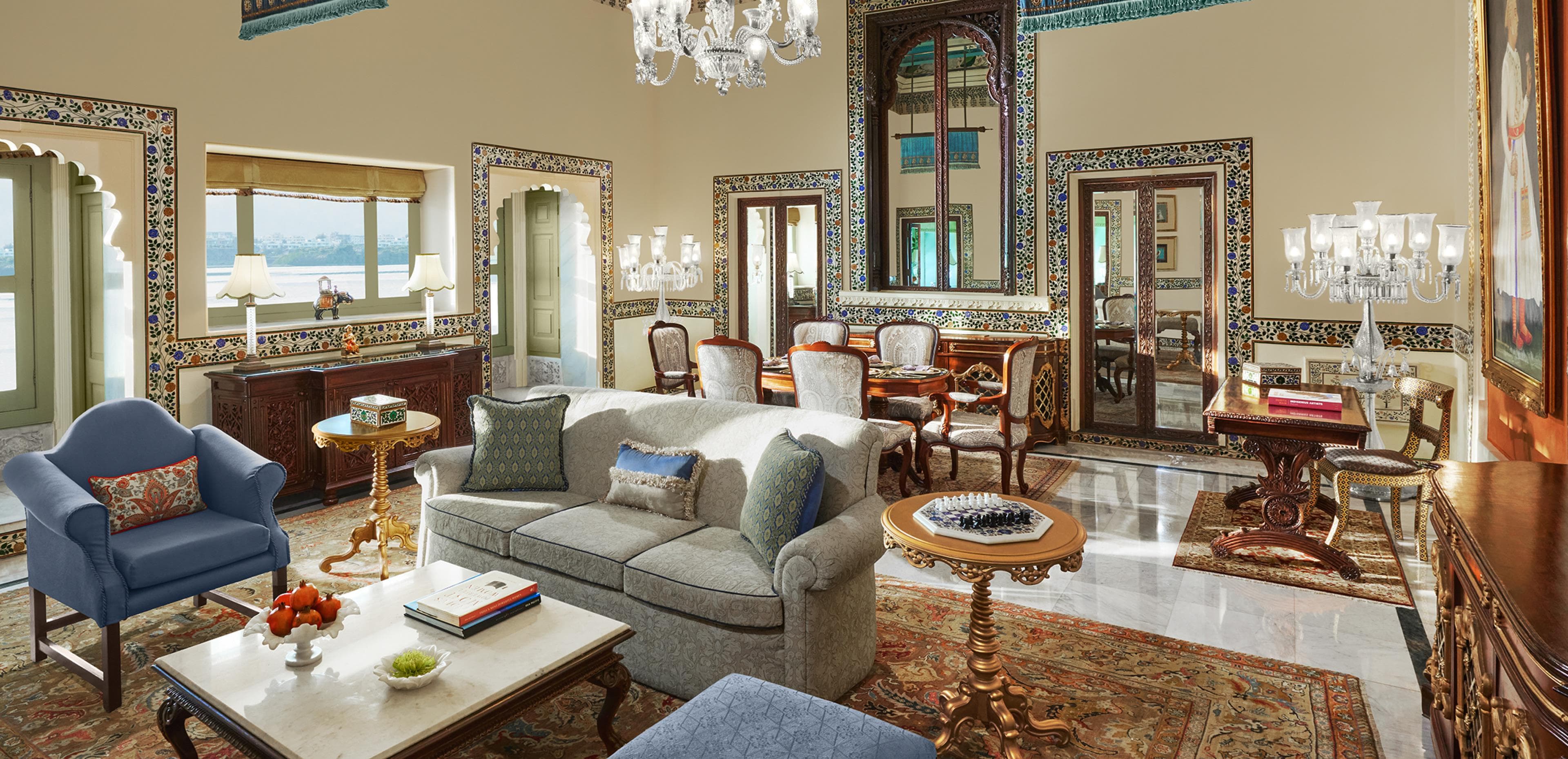 A dining room at Taj Lake Palace, Udaipur, with arched windows, chandeliers and marble detailing