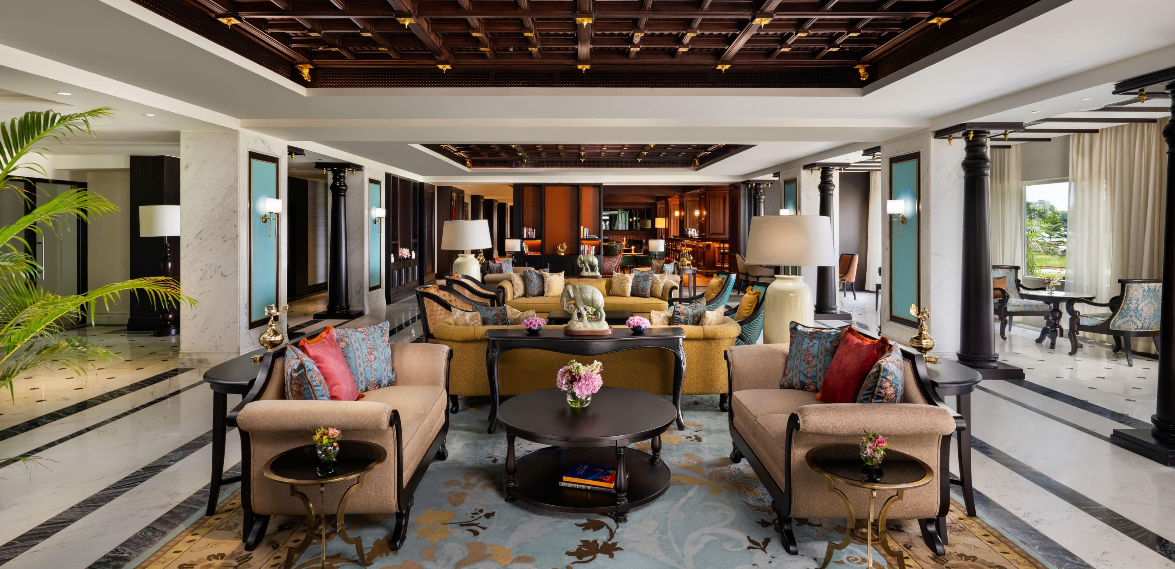The lobby lounge at Taj Malabar, Cochin, with columns, seating groups and polished floors