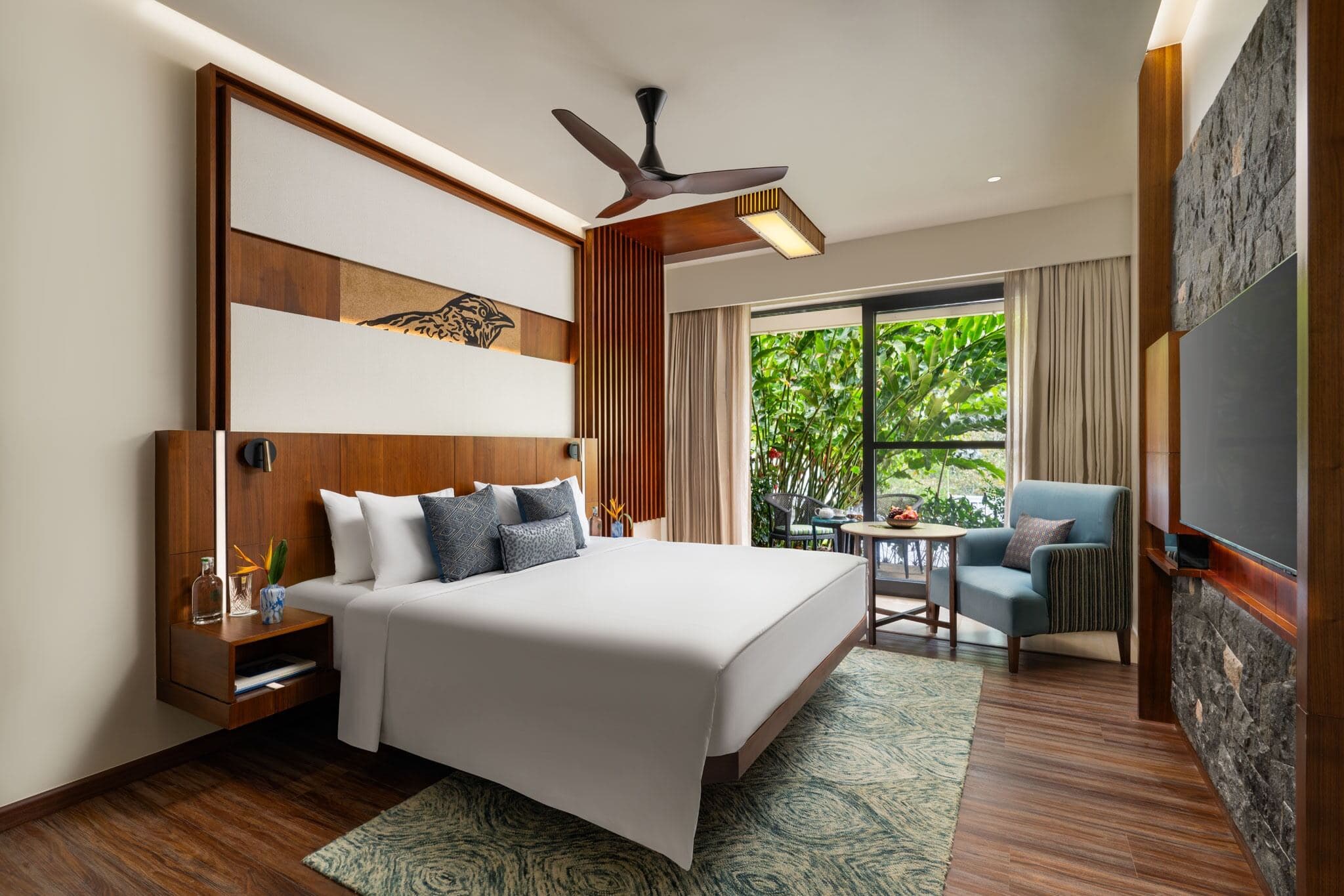 A Superior Room interior at Scenic, Munnar, in warm wood with a valley-facing window