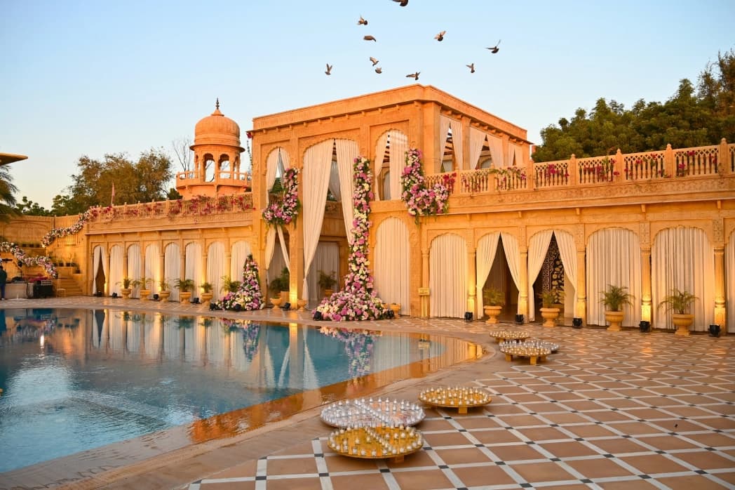 The outdoor swimming pool at Fort Rajwada, Jaisalmer, set among sandstone terraces