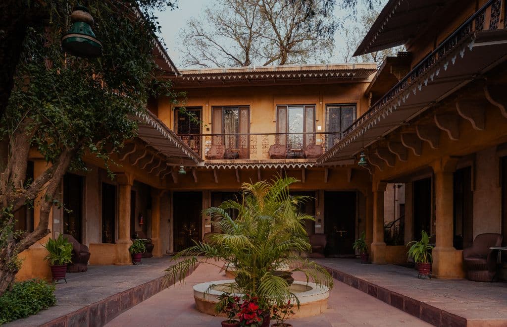 A Deluxe Room at Ajit Bhawan, Jodhpur, opening onto the garden lawn