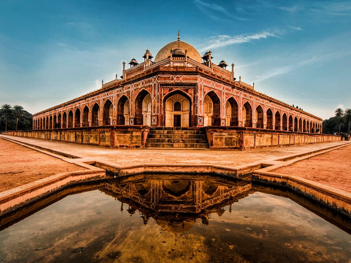 Humayun's Tomb, the 16th-century Mughal garden mausoleum in Delhi, mirrored in a garden pool