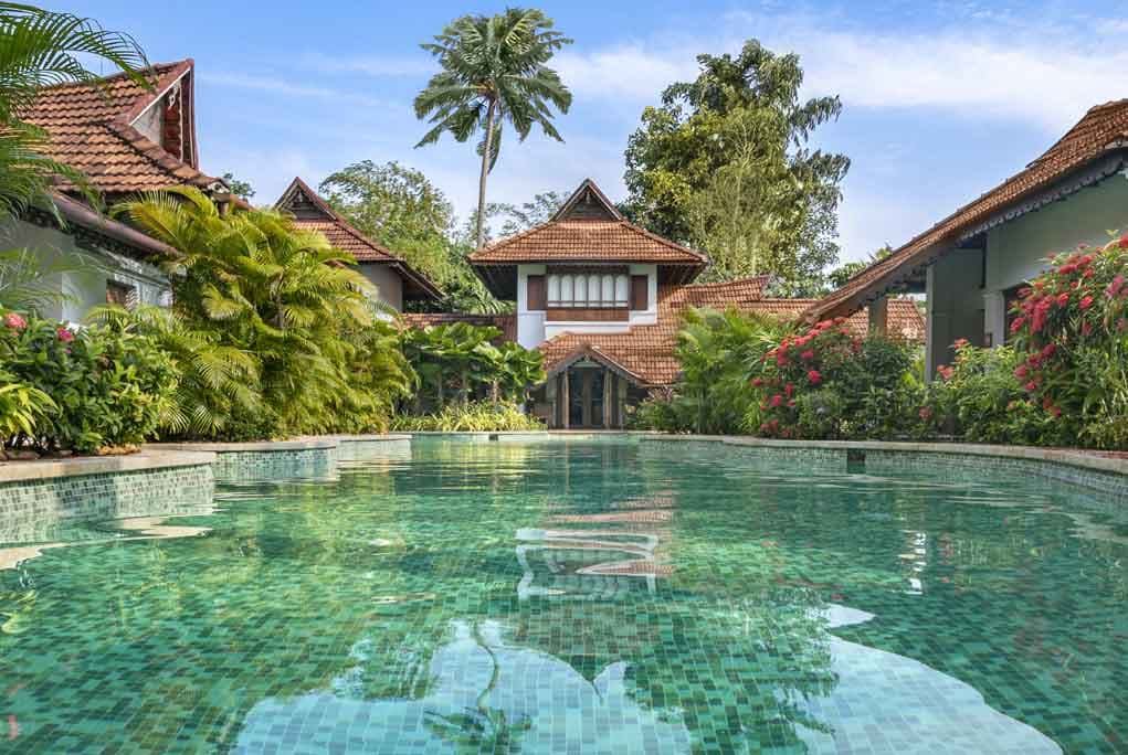 A meandering-pool villa at Kumarakom Lake Resort, the pool running past the terrace