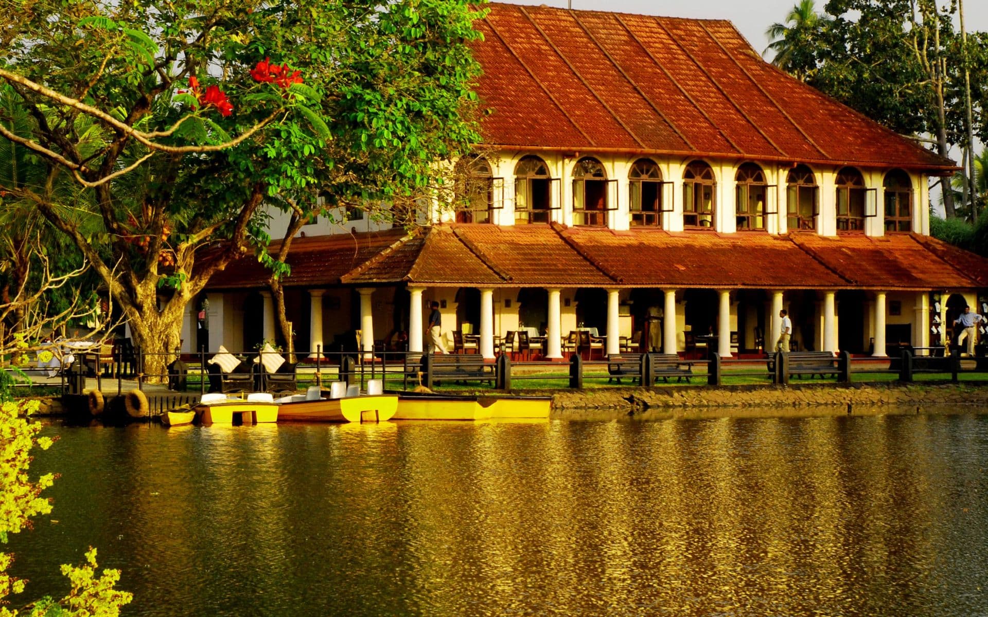 A villa and its verandah among rain trees at Taj Kumarakom Resort & Spa