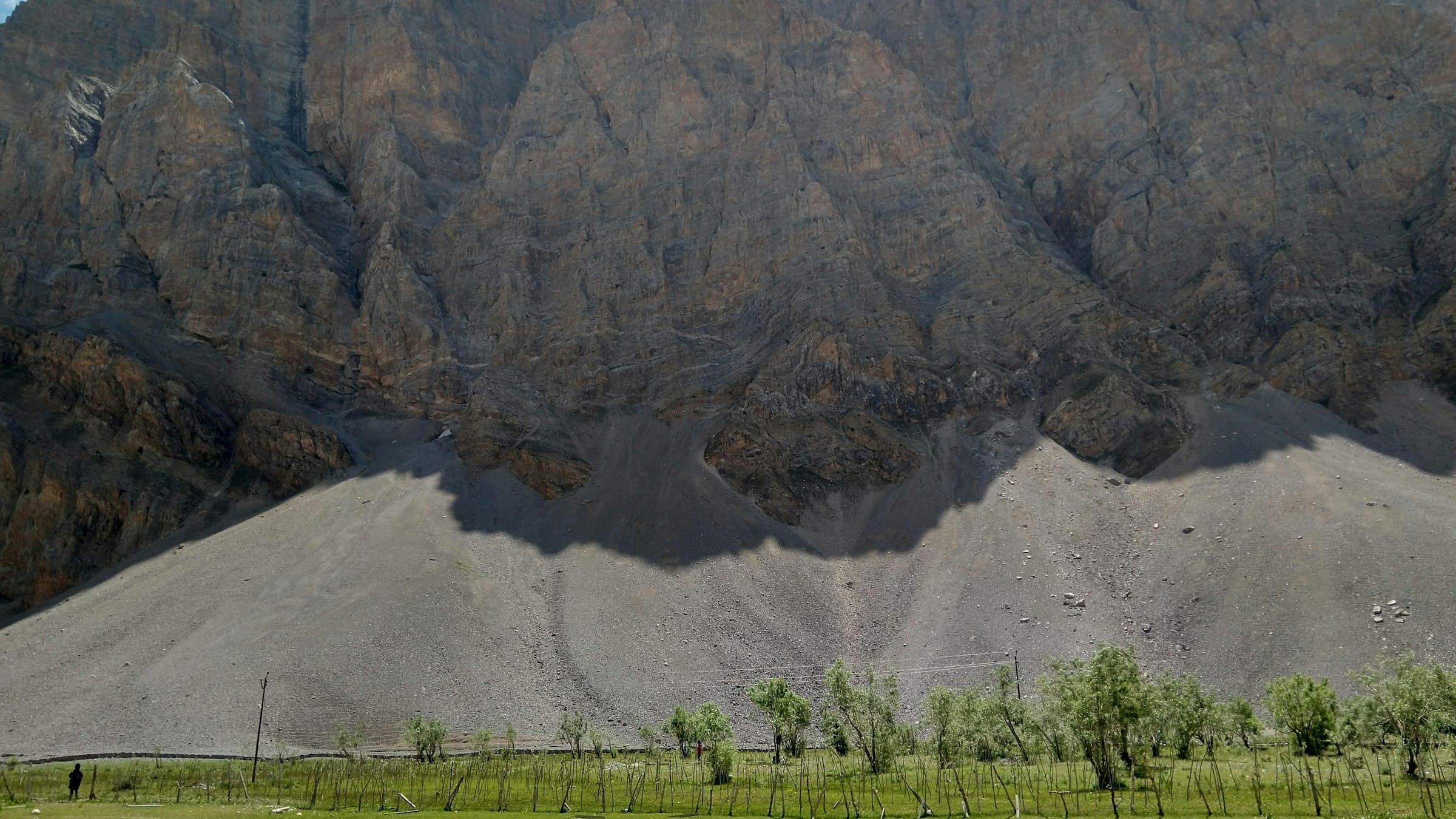 Green meadows run up to bare brown mountains near Drass in the Kargil district, the fertile western edge of Ladakh along the road to the Suru valley.