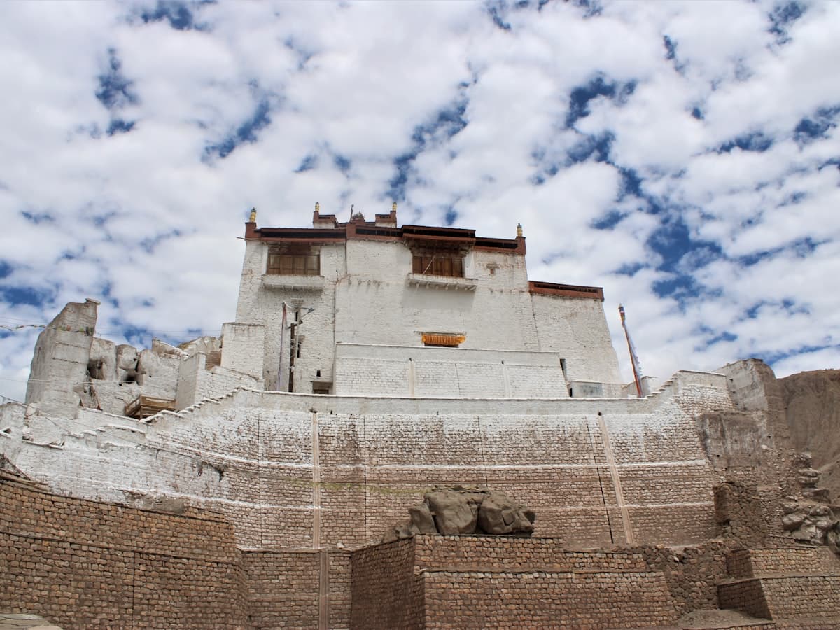 The ruined mud-brick towers of Basgo, a former royal citadel and temple complex crumbling along an eroded ridge above the Indus valley.