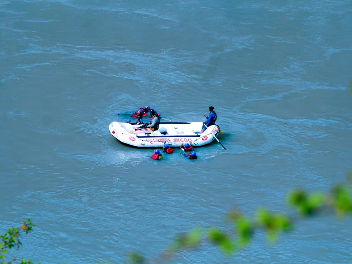 A paddle raft punches through white water on a fast Himalayan river, the kind of run the Zanskar gorge is famous for.