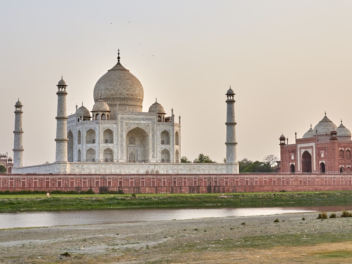 The Taj Mahal seen across the Yamuna river from the Mughal riverfront garden of Mehtab Bagh in Agra.
