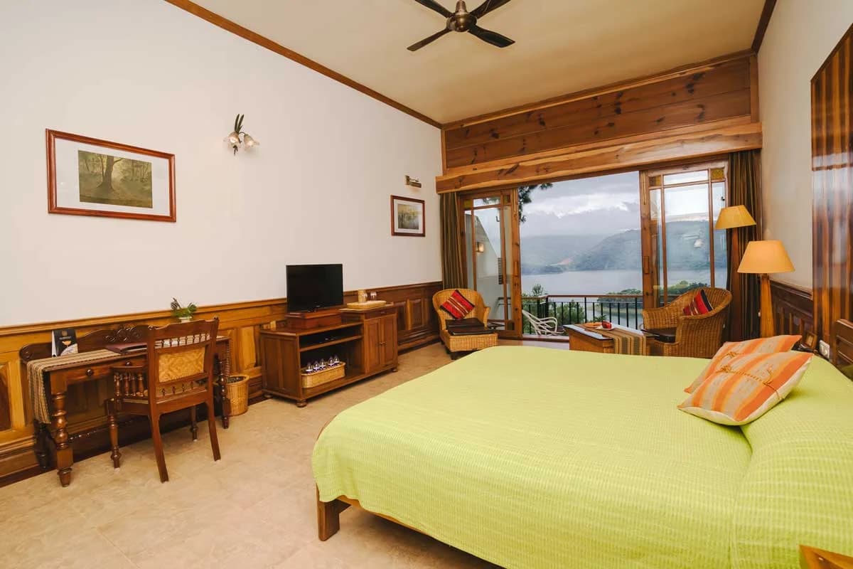 A Ri Kynjai Superior Lake Category room with a low bed and lake-facing windows.