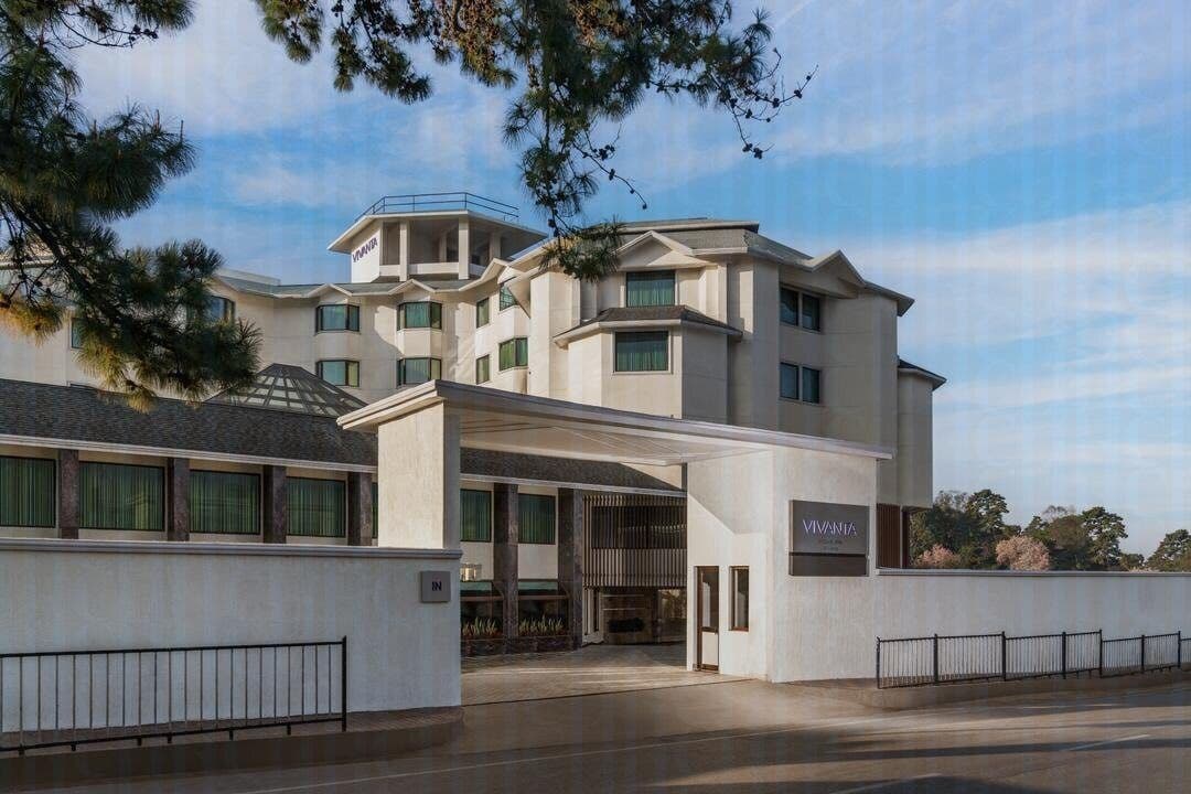 The tiered white facade of Vivanta Meghalaya, Shillong rising above its lower guest-room wings.