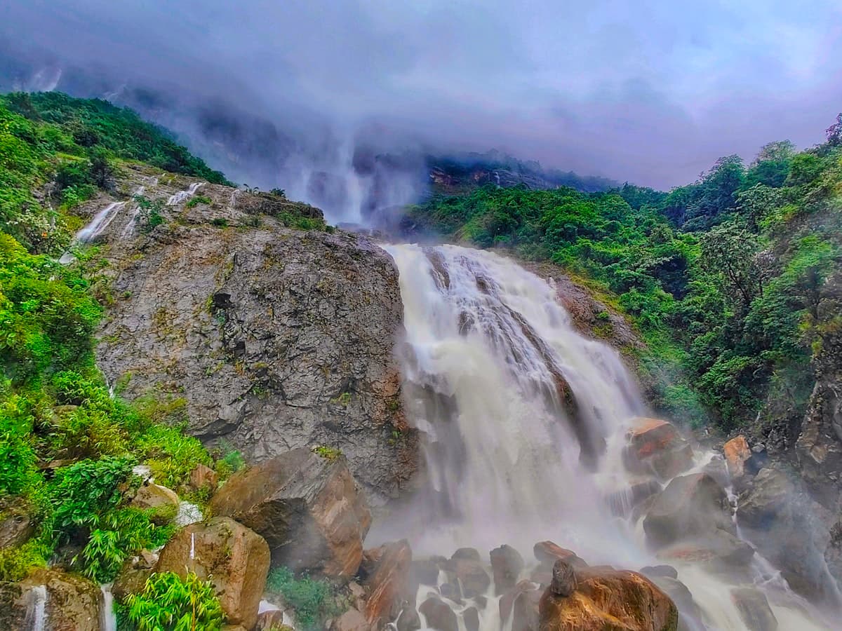 Kynrem Falls dropping in tiers through dense forest near Cherrapunji.