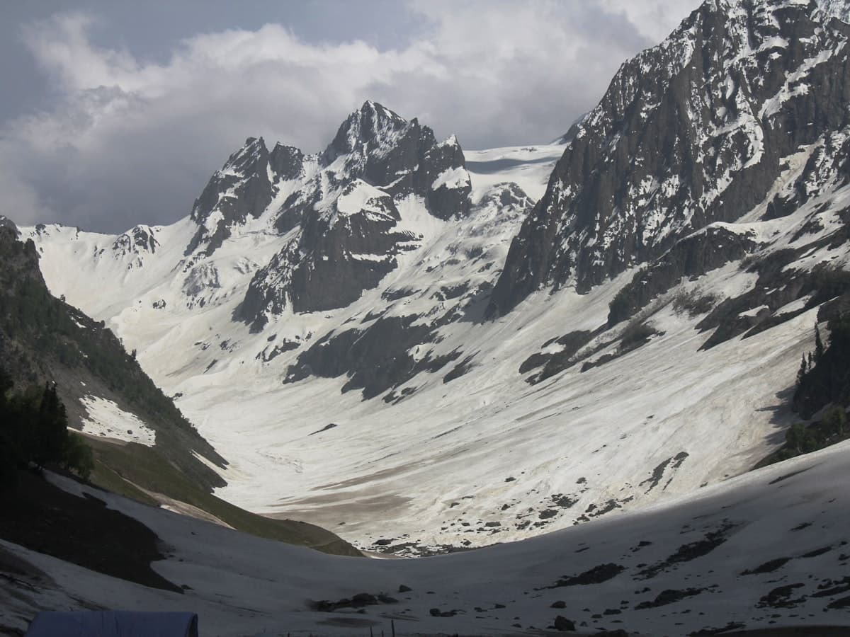 A snow-covered ridge above the Thajiwas glacier valley near Sonamarg in Kashmir, with rock and patchy summer snow.