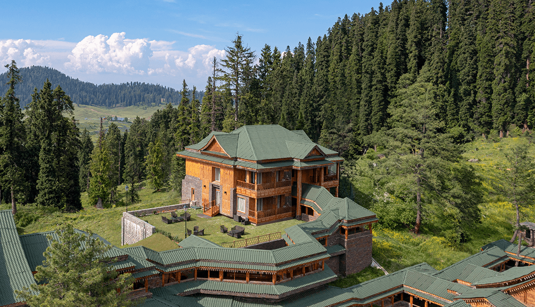 Aerial view of The Khyber Himalayan Resort & Spa set among pine forest at the edge of Gulmarg.