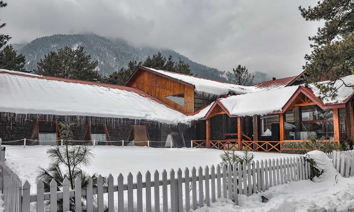 The snow-clad facade of Welcomhotel by ITC Hotels, Pine N Peak, Pahalgam in winter.