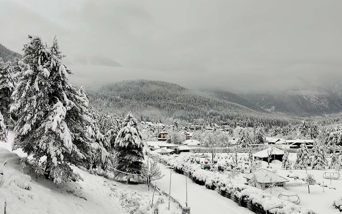 Welcomhotel Pine N Peak, Pahalgam viewed against the snow-clad Himalayan range.