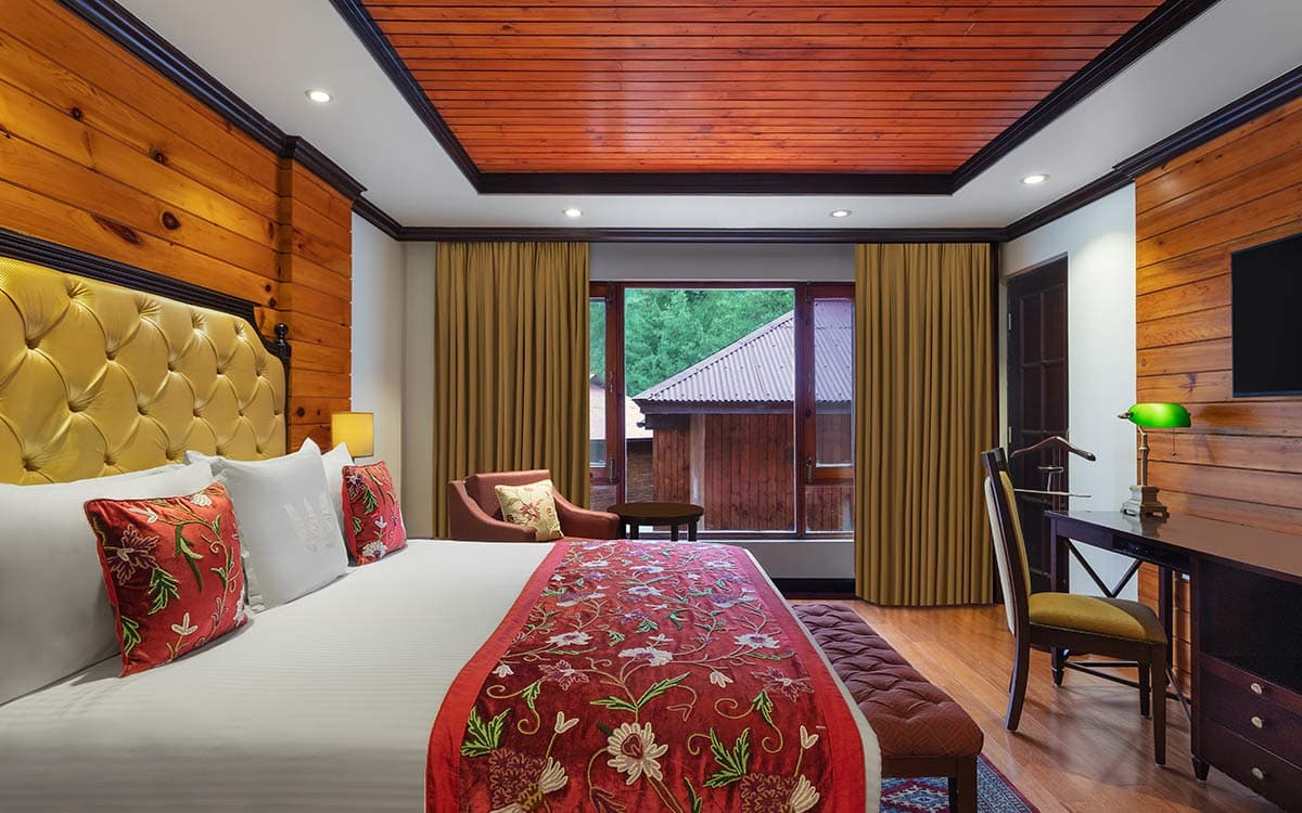 The master bedroom of a four-bedroom cottage at Welcomhotel Pine N Peak, Pahalgam.