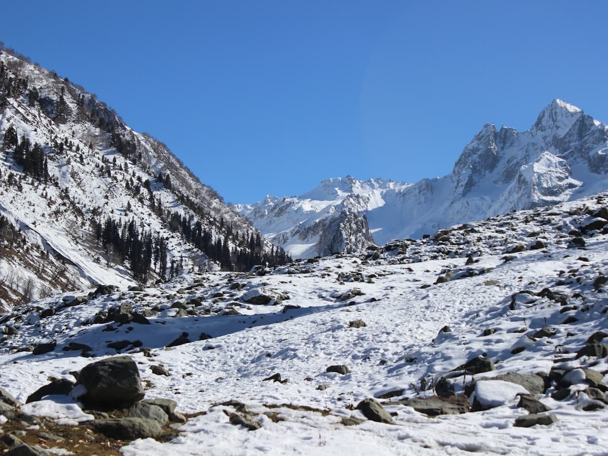 Snow-covered alpine terrain with bare peaks above Gulmarg.