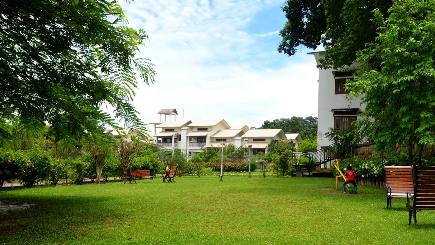 Lawns and garden with resort blocks at IORA - The Retreat, Kaziranga.
