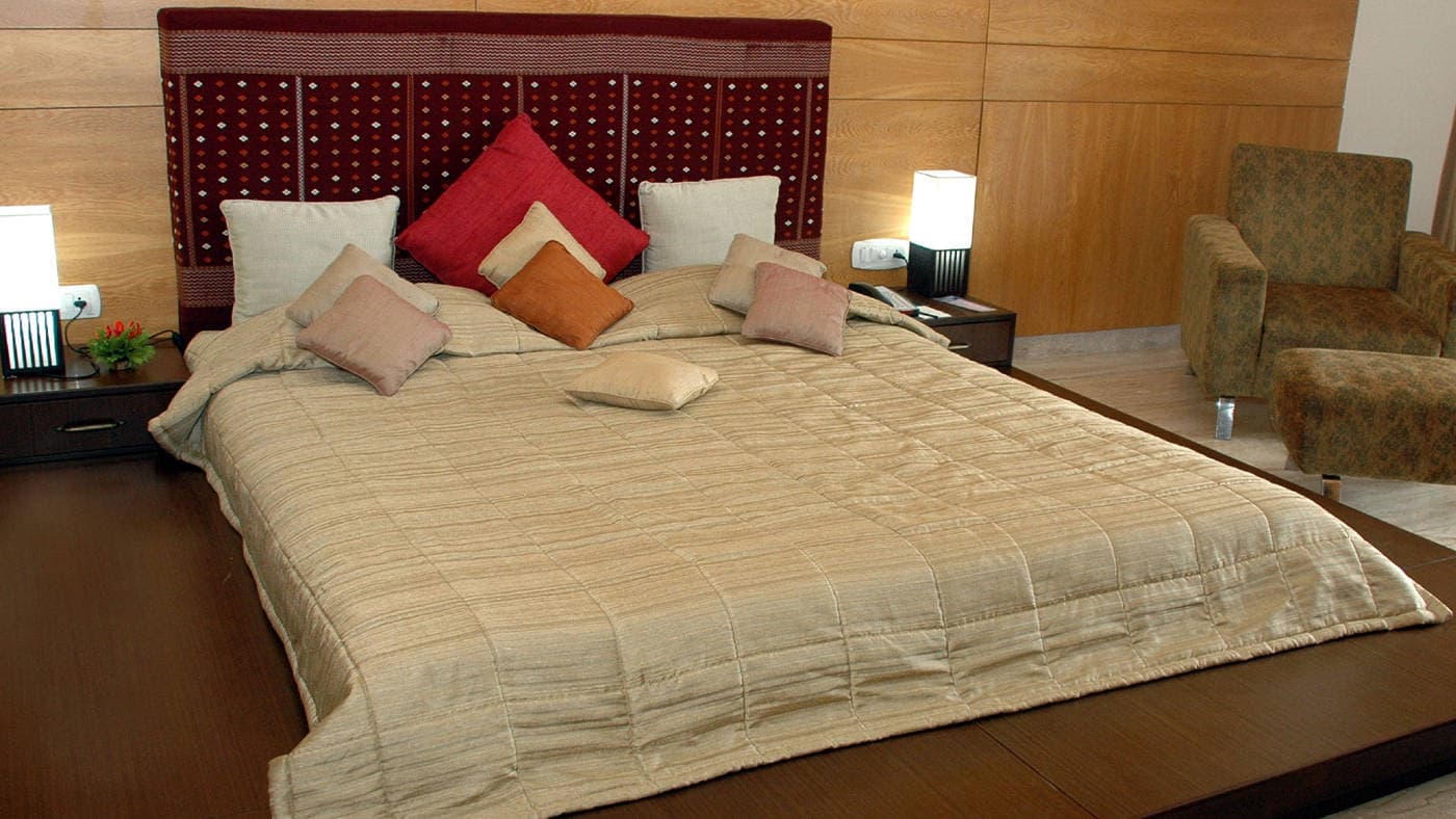 A guest room with a king bed and seating area at IORA - The Retreat.