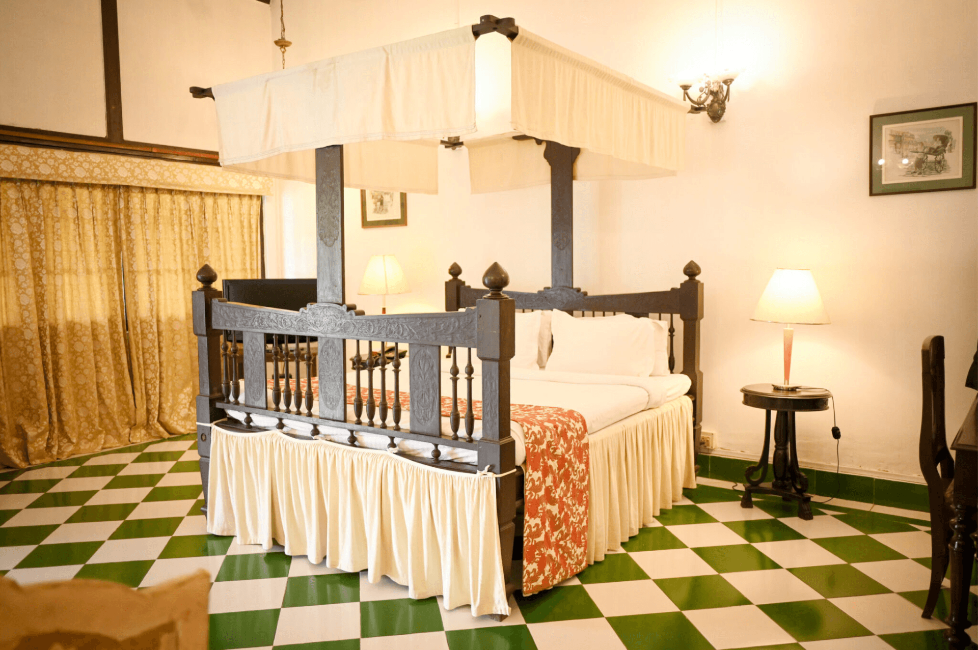 A guest room at Banyan Grove with a carved four-poster bed.