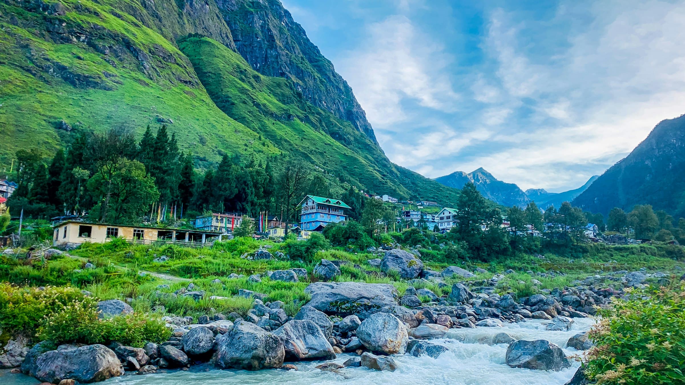 The village of Lachung in North Sikkim set on a mountainside above a fast river.
