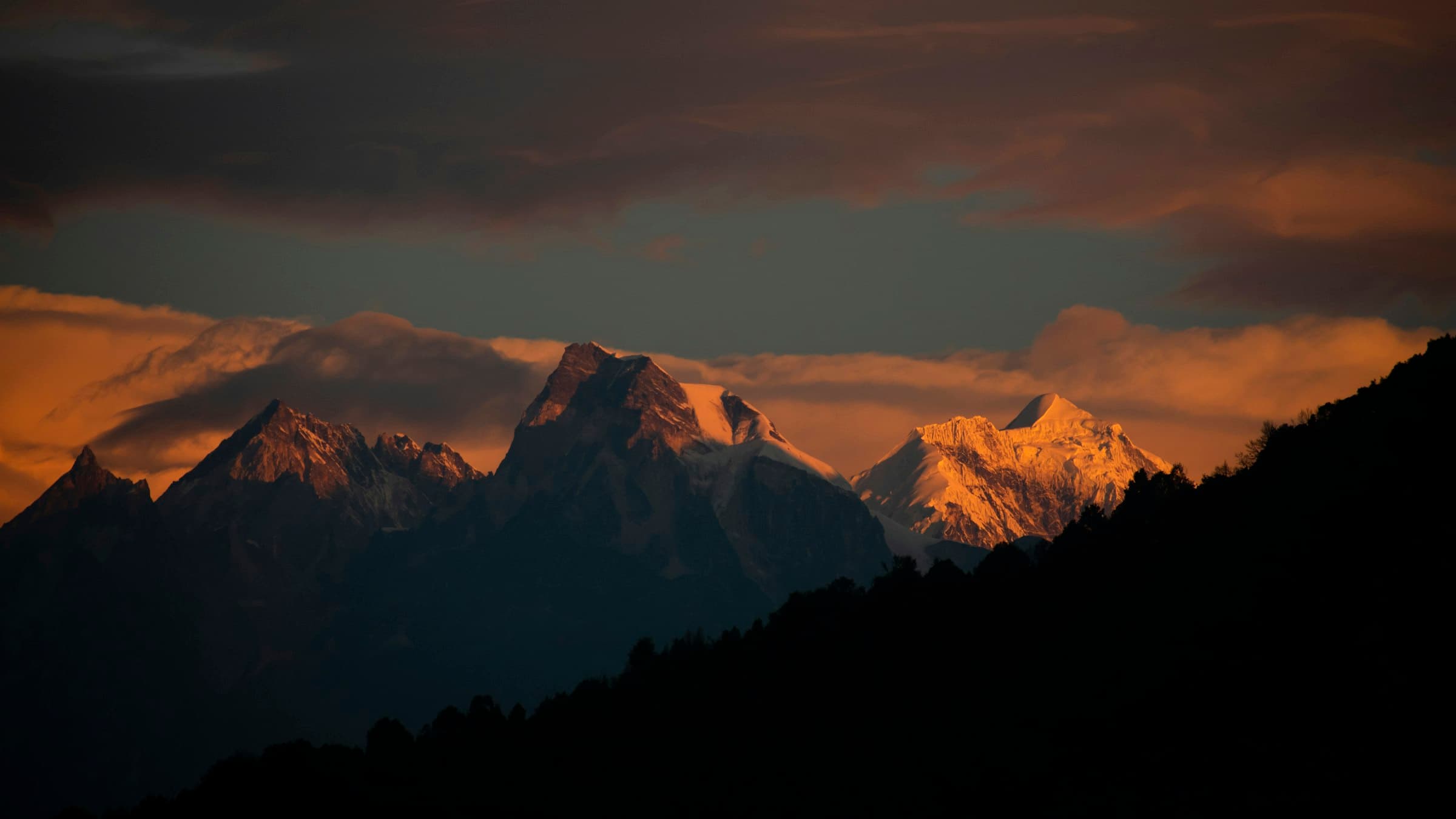 Cloud-wrapped Himalayan ridgelines of the Kanchenjunga range seen from Ravangla in South Sikkim.
