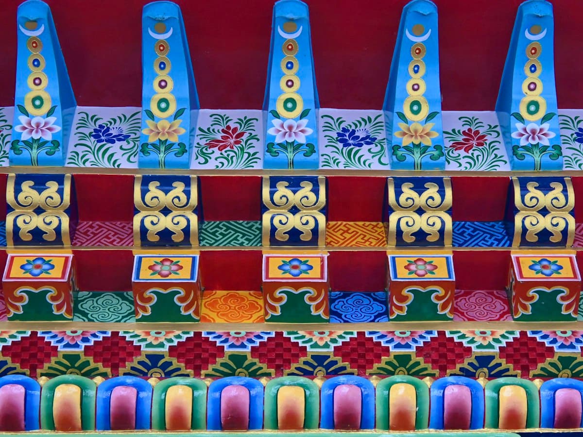 Ornate multicoloured Tibetan Buddhist woodwork on the facade of Enchey Monastery in Gangtok, Sikkim.