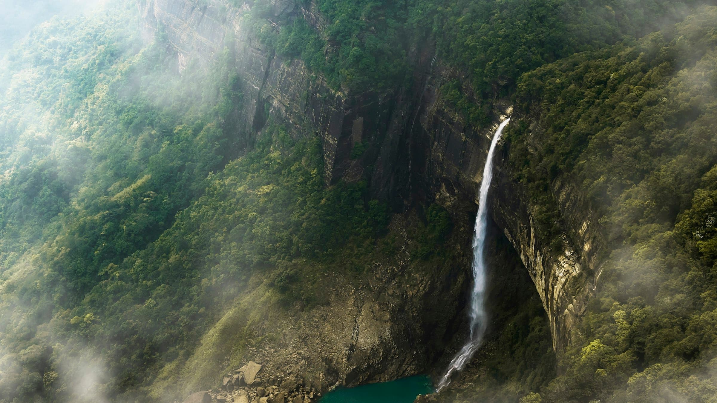 Nohkalikai Falls drops from a forested cliff into a plunge pool in Meghalaya, India.