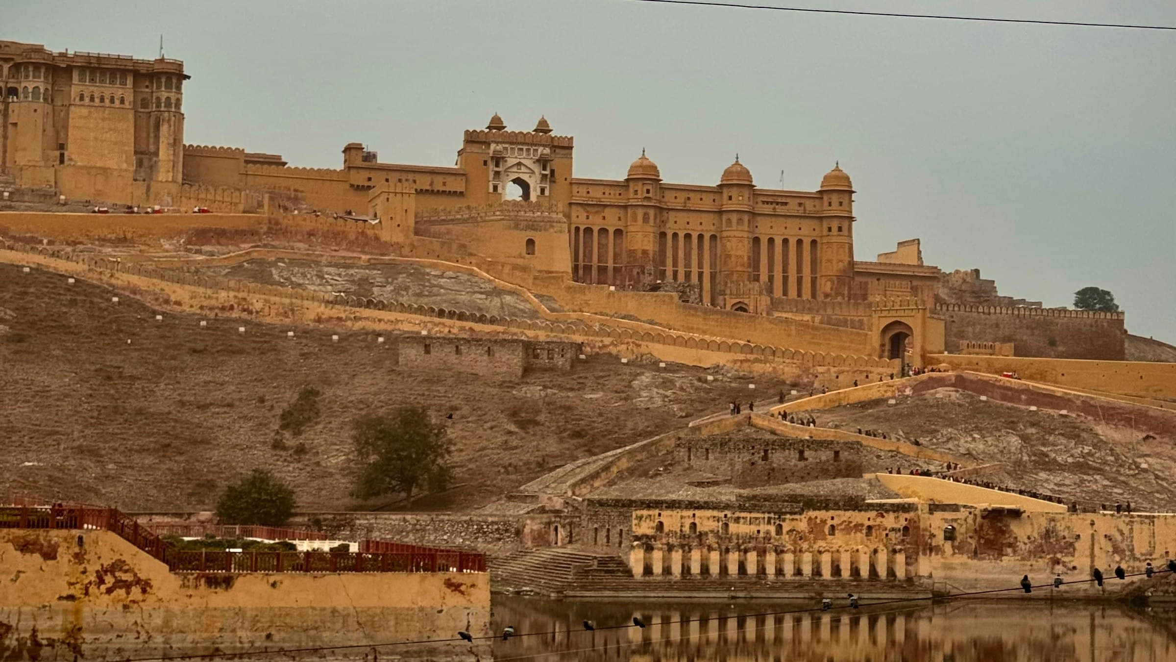 Amer Fort stands on a hillside above a lake near Jaipur, Rajasthan.