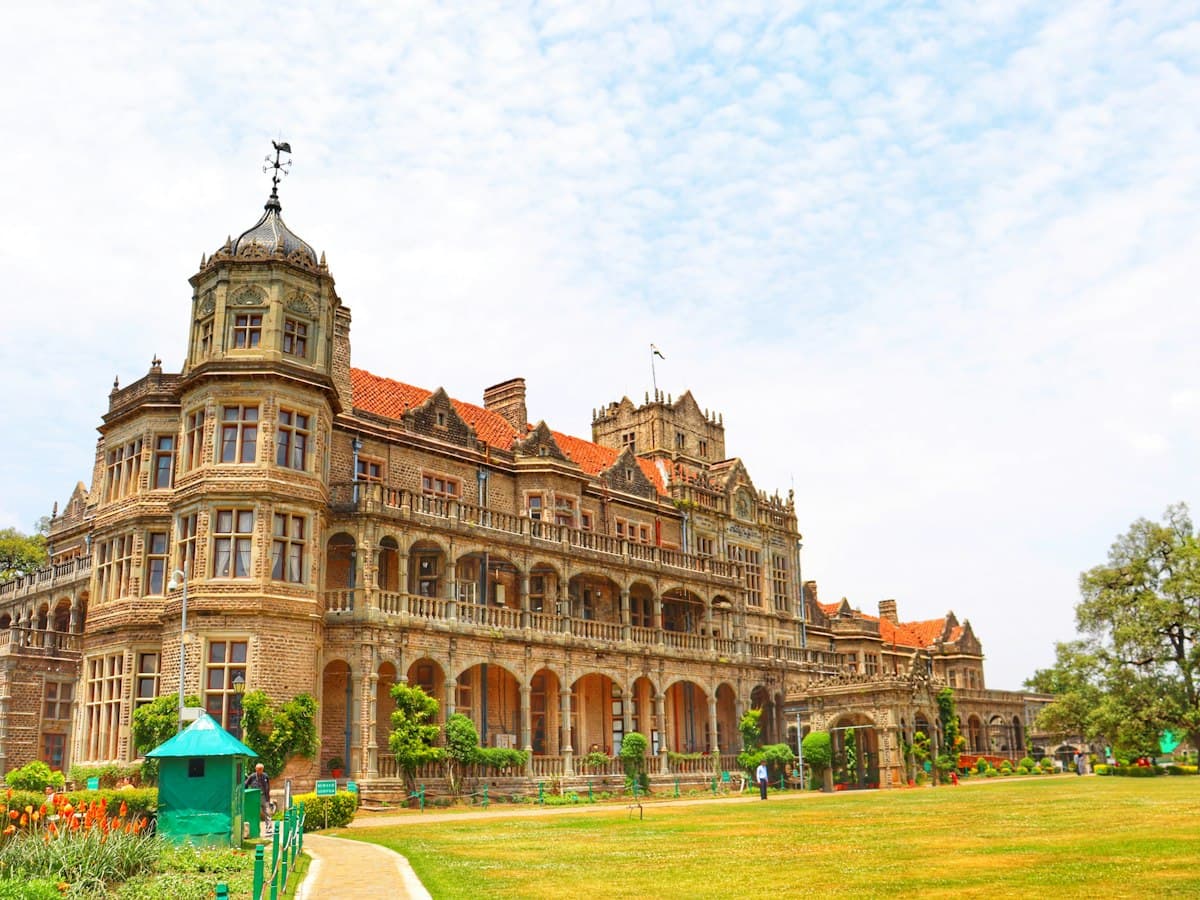 The grey stone Viceregal Lodge (Rashtrapati Niwas) in Shimla stands behind its front lawns.