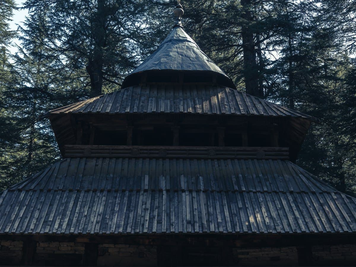 The tall wooden pagoda-roofed Hadimba Devi Temple stands among deodar cedars in Manali.