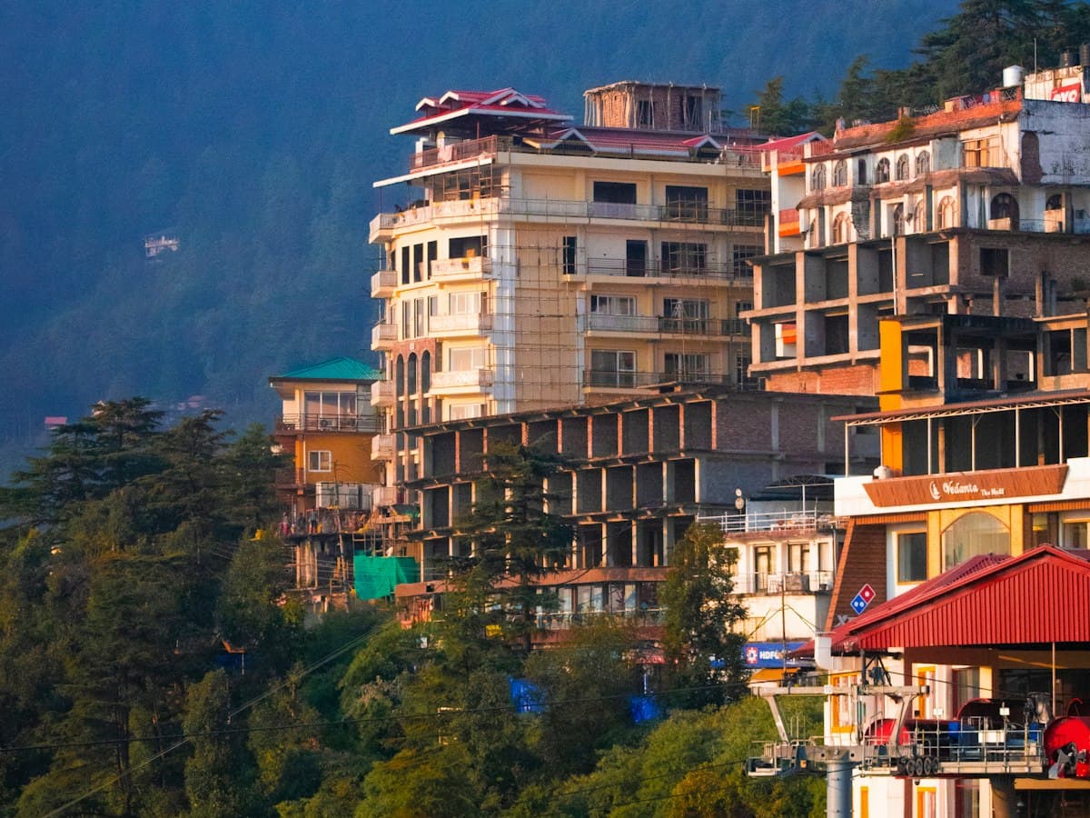 The hillside town of McLeodganj above Dharamshala with the mountains rising behind it.