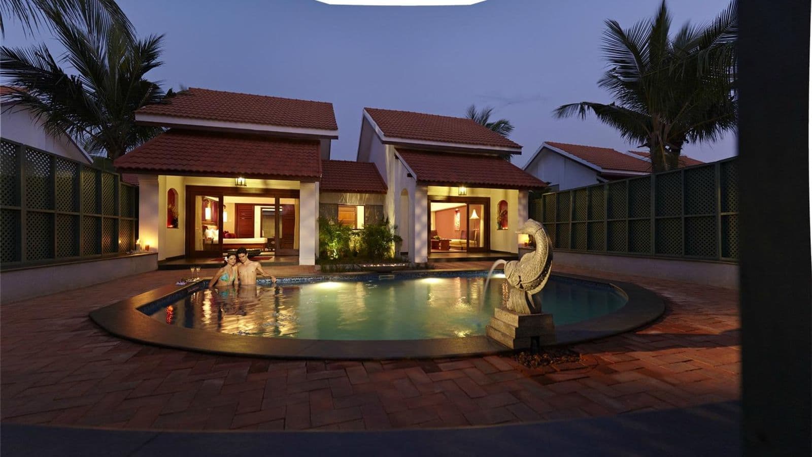 Villa with a private plunge pool lit in the evening at Radisson Blu Resort Temple Bay, Mamallapuram