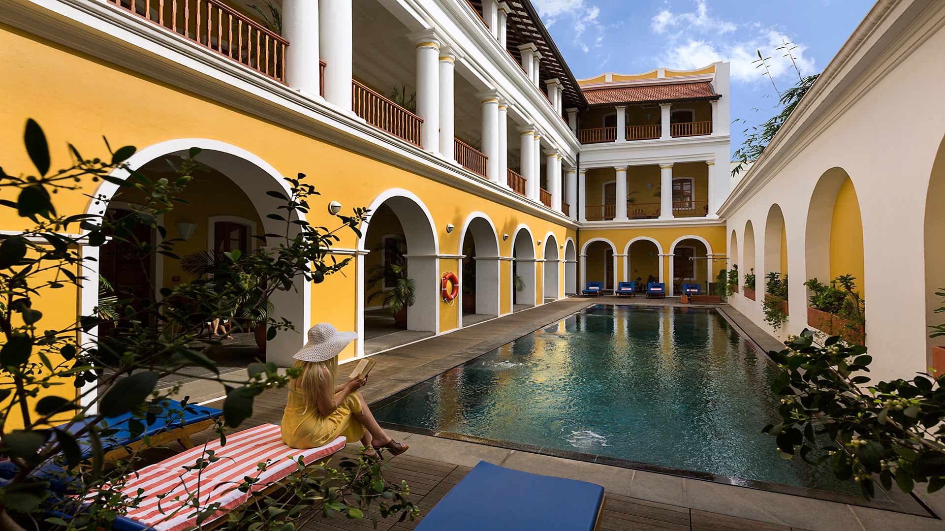 Courtyard swimming pool enclosed by arched colonnades at Palais de Mahe, Puducherry