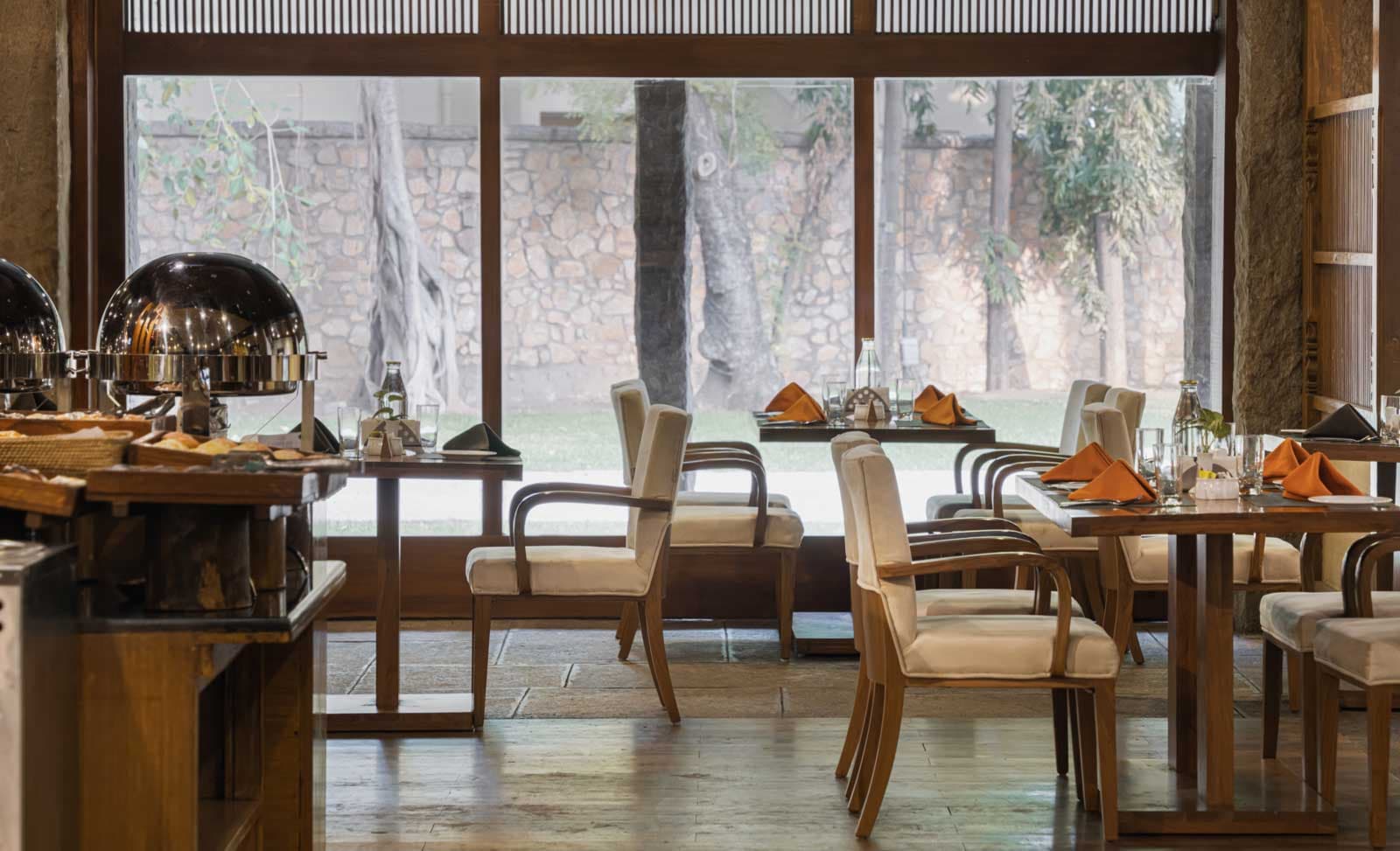 The Banyan restaurant interior with dining tables at Heritage Madurai, Madurai