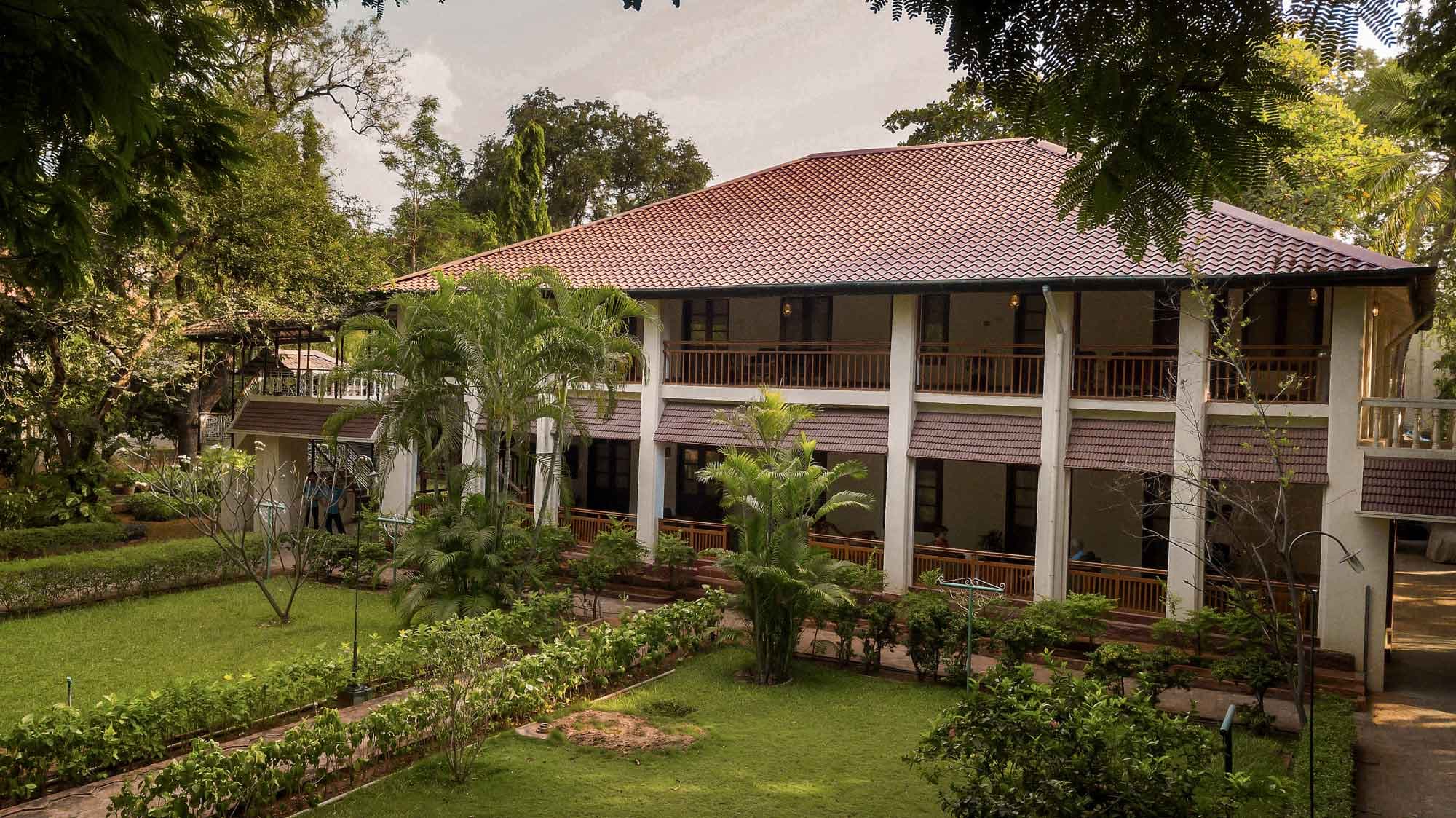 Deluxe room with a king bed and seating area at Heritage Madurai, Madurai